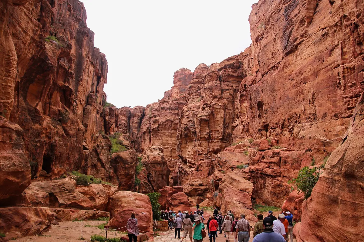 Visitors walking the paved Siq into Petra on a trip from Jerusalem to Petra